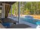 Private pool oasis with sun loungers and a captivating waterfall feature, perfect for relaxation at 3718 Sandy Gate Ln, Mount Pleasant, SC 29466