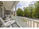 Cozy front porch offers chairs and a view of the street and lush greenery at 3718 Sandy Gate Ln, Mount Pleasant, SC 29466
