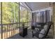 Relaxing screened porch with comfortable seating, curtains, and a view of the wooded backyard at 3718 Sandy Gate Ln, Mount Pleasant, SC 29466