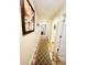Hallway with tile floor and runner lead to a living room and bathroom in this house at 4262 Mariners Watch, Kiawah Island, SC 29455