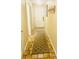 Hallway with decorative rug provides a welcoming transition between living spaces and the front entrance at 4262 Mariners Watch, Kiawah Island, SC 29455