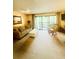Living room with beige sofa and white coffee table by the window lead to the patio at 4262 Mariners Watch, Kiawah Island, SC 29455