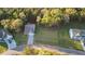 Aerial shot of a home with a driveway, lawn, and lots of trees at 4263 Hugh Bennett Dr, Johns Island, SC 29455