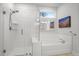Bright bathroom features a glass shower and soaking tub beneath a window with natural light at 4263 Hugh Bennett Dr, Johns Island, SC 29455