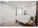 This bedroom includes a four-poster bed with a plant on the nightstand next to the window at 4263 Hugh Bennett Dr, Johns Island, SC 29455