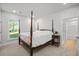 This bedroom has a window bringing in natural light with a four-poster bed at 4263 Hugh Bennett Dr, Johns Island, SC 29455