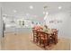 Open-concept dining area with a view into the modern kitchen and living spaces with great lighting at 4263 Hugh Bennett Dr, Johns Island, SC 29455