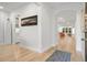 Bright entryway featuring gleaming wood floors, soft white walls, arched doorway and decorative rug at 4263 Hugh Bennett Dr, Johns Island, SC 29455