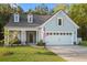 Charming exterior elevation featuring a two-car garage, dormer windows and a inviting covered front porch at 4263 Hugh Bennett Dr, Johns Island, SC 29455