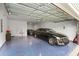 Organized garage with epoxy flooring, car, storage, and overhead door at 4263 Hugh Bennett Dr, Johns Island, SC 29455