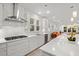 Modern kitchen boasts white cabinets, stainless appliances, stone countertops and recessed lighting at 4263 Hugh Bennett Dr, Johns Island, SC 29455