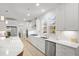 This modern kitchen is filled with white cabinets, stainless steel appliances and gorgeous countertops at 4263 Hugh Bennett Dr, Johns Island, SC 29455