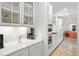 Spacious kitchen features white cabinets, stainless steel appliances, recessed lighting and stone countertops at 4263 Hugh Bennett Dr, Johns Island, SC 29455