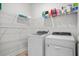 Laundry room includes a front loading washer and dryer with wire shelving above at 4263 Hugh Bennett Dr, Johns Island, SC 29455