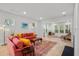Inviting living room featuring a comfortable sofa, large windows, and stylish decor with seamless access to sitting area at 4263 Hugh Bennett Dr, Johns Island, SC 29455
