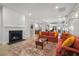 Cozy living room showcasing an electric fireplace, comfortable seating, and seamless flow into dining area and kitchen at 4263 Hugh Bennett Dr, Johns Island, SC 29455