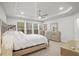 Serene main bedroom with ample natural light, a tray ceiling, and a mirrored dresser creating a relaxing retreat at 4263 Hugh Bennett Dr, Johns Island, SC 29455
