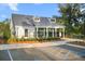 Exterior view of the community pool house with accessible parking and beautifully maintained landscaping at 4263 Hugh Bennett Dr, Johns Island, SC 29455