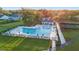 Community pool, and tennis courts on a sunny day with grassy surrounding and seating at 4263 Hugh Bennett Dr, Johns Island, SC 29455