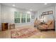 Bright sitting area with large windows, comfortable seating, and a decorative tree for a relaxing ambiance at 4263 Hugh Bennett Dr, Johns Island, SC 29455