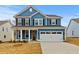 Charming blue two-story home with a front-facing two-car garage and well-manicured lawn at 503 Fiskdale Cir, Summerville, SC 29486
