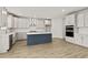 Modern kitchen with white cabinetry, stainless steel appliances, and a stylish blue island at 503 Fiskdale Cir, Summerville, SC 29486