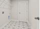 A functional laundry room with star patterned floor and shelving, ready for appliances at 503 Fiskdale Cir, Summerville, SC 29486