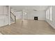 Bright, open living space with wood floors, a staircase, and an adjacent living room with a fireplace at 503 Fiskdale Cir, Summerville, SC 29486