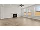Open-concept living room with modern fireplace and large windows bringing in plenty of light at 503 Fiskdale Cir, Summerville, SC 29486