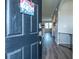 Inviting entryway with hardwood floors, a charming decor sign, and a view into the living spaces at 5138 Preserve Blvd, Ladson, SC 29456