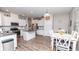 Modern kitchen with white cabinets, granite countertops, stainless steel appliances, and a functional center island at 5138 Preserve Blvd, Ladson, SC 29456
