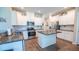 Modern kitchen featuring stainless steel appliances, granite countertops, white cabinets, and center island at 5138 Preserve Blvd, Ladson, SC 29456