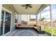 Screened-in patio with ceiling fan, outdoor sofa, and view of the backyard at 5138 Preserve Blvd, Ladson, SC 29456