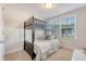 Cozy bedroom with a bunk bed, a window with blinds, and neutral decor at 518 Green Fern Dr, Summerville, SC 29483