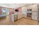 Bright, open kitchen featuring white cabinets, stainless appliances, and a large island overlooking the living area at 518 Green Fern Dr, Summerville, SC 29483