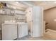 Functional laundry room with washer, dryer, shelving, and stylish tile flooring at 518 Green Fern Dr, Summerville, SC 29483