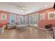 Bright living room with a comfortable sectional sofa, ceiling fan, and glass patio doors leading to the backyard at 518 Green Fern Dr, Summerville, SC 29483