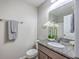 Well-lit bathroom featuring a granite countertop, decorative flower arrangement and modern fixtures at 531 Truman Dr, Goose Creek, SC 29445