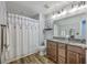 Bathroom with double sink vanity, shower/tub combo, and modern lighting at 531 Truman Dr, Goose Creek, SC 29445