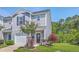 Gray townhome with a garage and a landscaped front yard, featuring vibrant pink flowers and lush greenery at 531 Truman Dr, Goose Creek, SC 29445