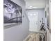 Bright hallway featuring modern decor, hardwood floors, and a view of the front door and stairs at 531 Truman Dr, Goose Creek, SC 29445