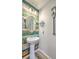 Charming powder room with pedestal sink and rustic wood accent wall at 531 Truman Dr, Goose Creek, SC 29445