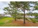 A backyard with tall trees, grass, mulch and boardwalk leading to a dock at 545 Towles Crossing Dr # 29455, Johns Island, SC 29455