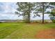 A backyard with tall trees, grass, mulch and boardwalk leading to a dock at 545 Towles Crossing Dr # 29455, Johns Island, SC 29455