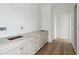 Long counter with stone countertop and undermount sinks next to hardwood floors and an open doorway at 545 Towles Crossing Dr # 29455, Johns Island, SC 29455
