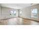 An airy bedroom with wainscoting, hardwood floors, and three windows offering natural light and scenic views at 545 Towles Crossing Dr # 29455, Johns Island, SC 29455
