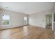 Light-filled bedroom features wainscoting, hardwood floors, and dual windows providing a bright and airy atmosphere at 545 Towles Crossing Dr # 29455, Johns Island, SC 29455