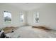 Bright, spacious bedroom boasts large windows offering beautiful neighborhood views and ample sunlight at 545 Towles Crossing Dr # 29455, Johns Island, SC 29455