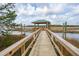 View down the boardwalk leading to a covered dock on the river at 545 Towles Crossing Dr # 29455, Johns Island, SC 29455