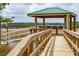 Waterfront gazebo with wooden walkway and ramp offering serene views and access to the water at 545 Towles Crossing Dr # 29455, Johns Island, SC 29455